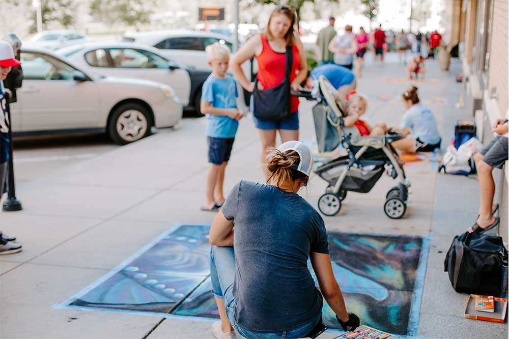 Artist painting at Chalk Art Festival - Omaha - Midtown Crossing