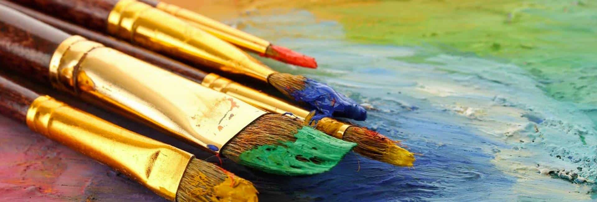 Paint brushes on colorful background