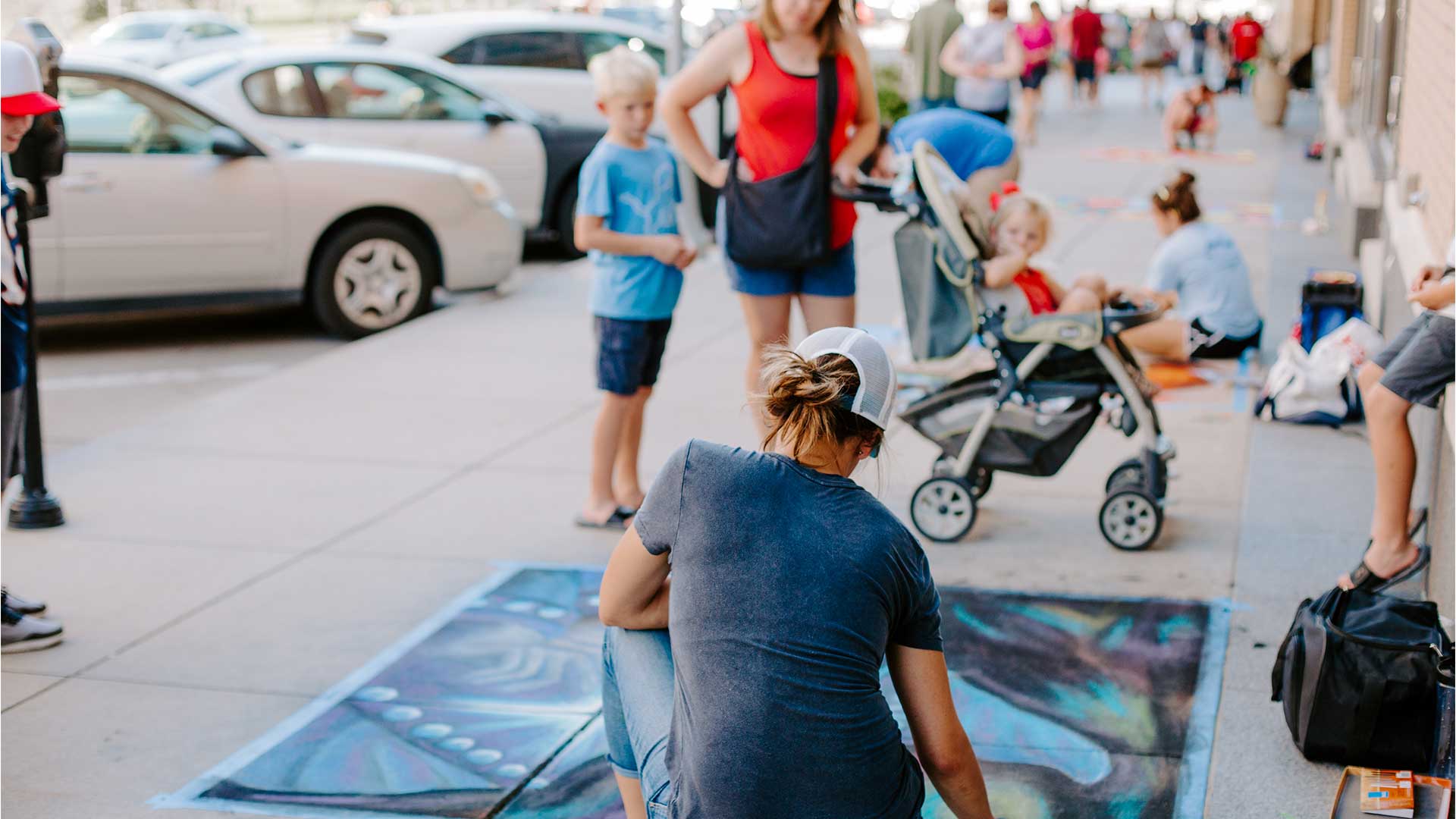 Artist chalking at Omaha Chalk Art Festival at Midtown Crossing