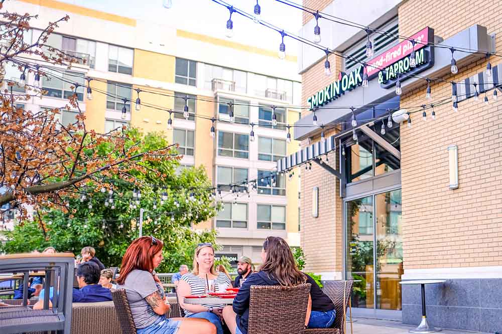 Group dining on patio at Smokin Oak in Midtown Crossing