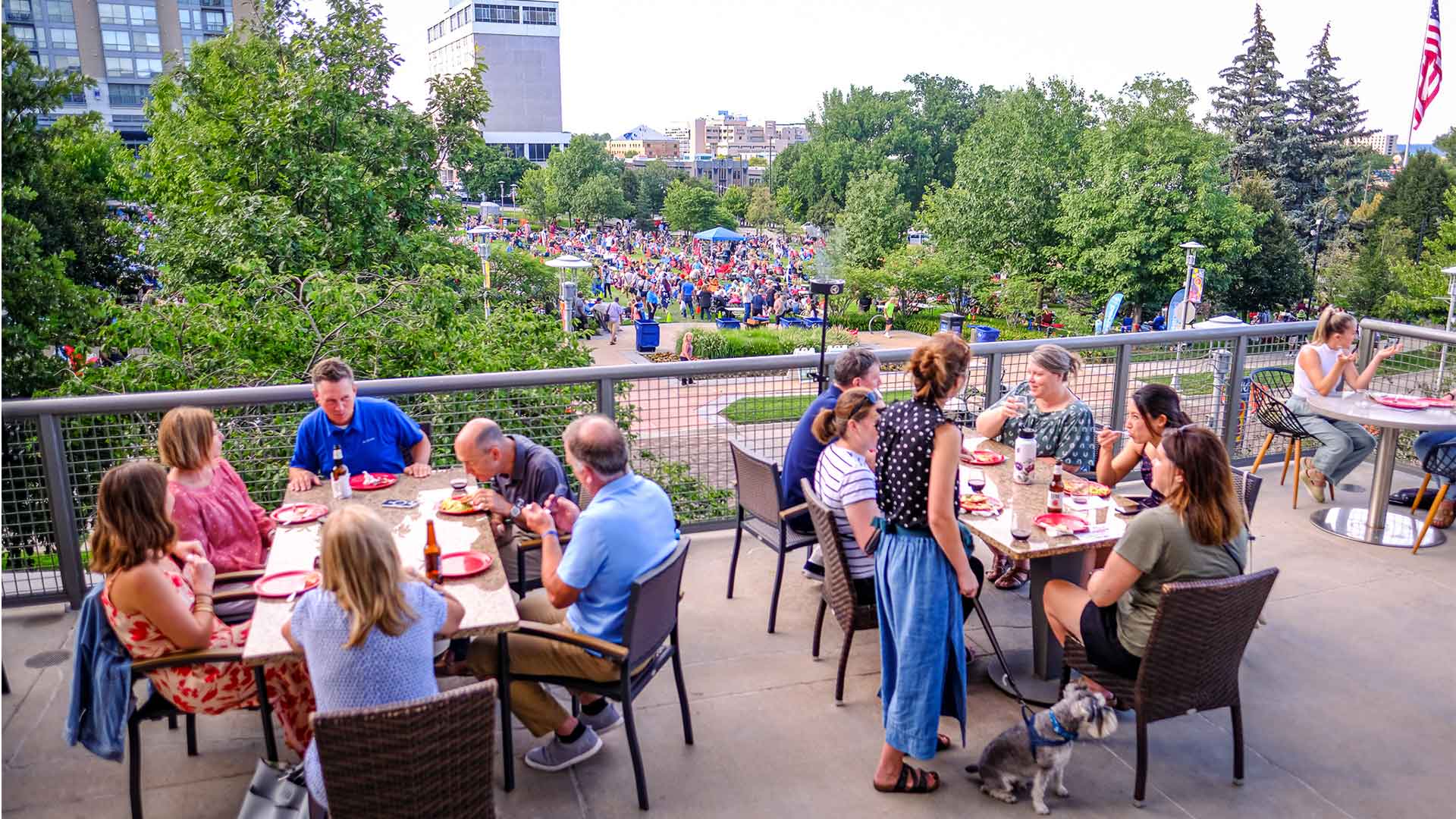 People dining on Smokin Oak patio overlooking Turner Park