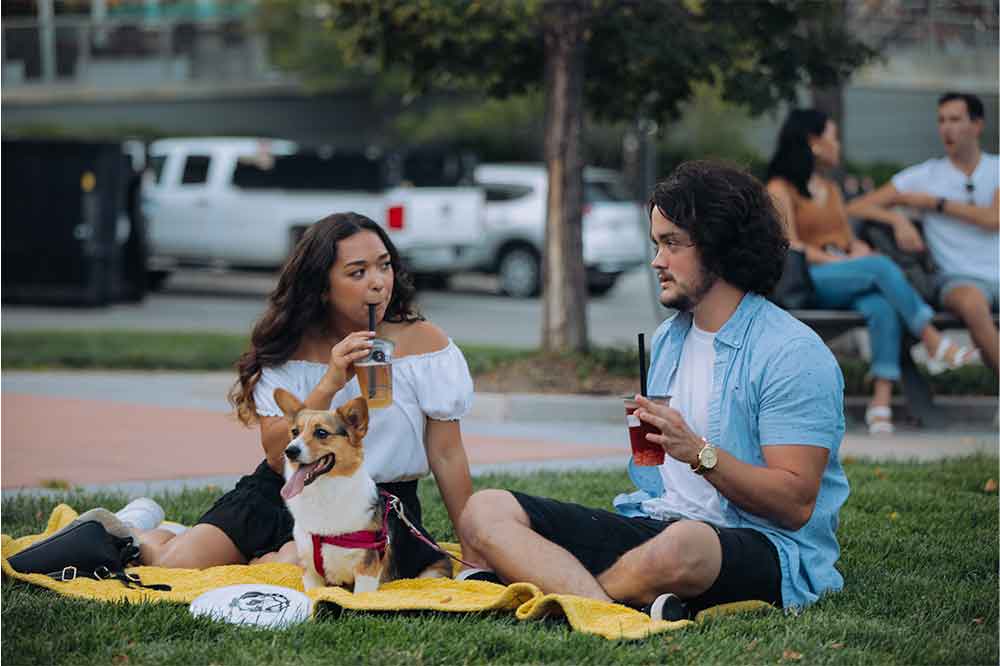 Two people and dog enjoying picnic in Turner Park