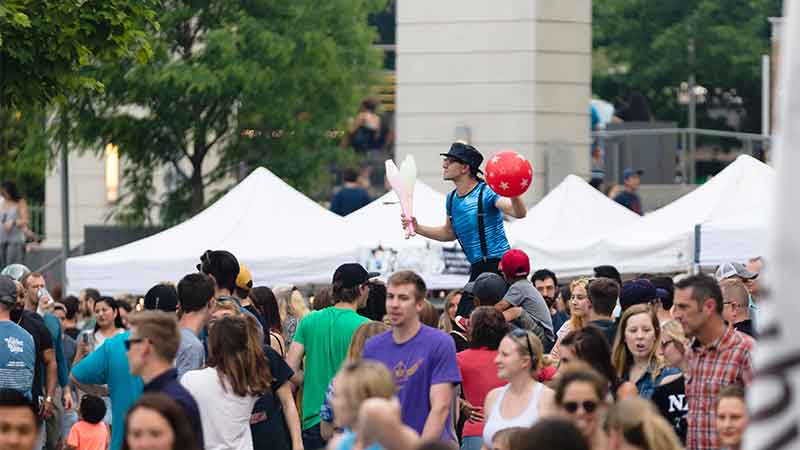 Stiltwalker performing at Midtown Crossing